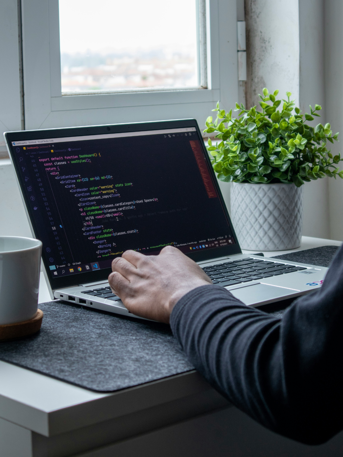 A man coding on a laptop